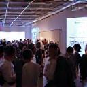 Group of people networking at a digital event, representing community connections and professional growth.