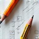 Pencil and paper icon with digital screen in the background, symbolizing content creation for digital platforms.
