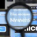 Magnifying glass over a website, representing SEO analysis and optimization.